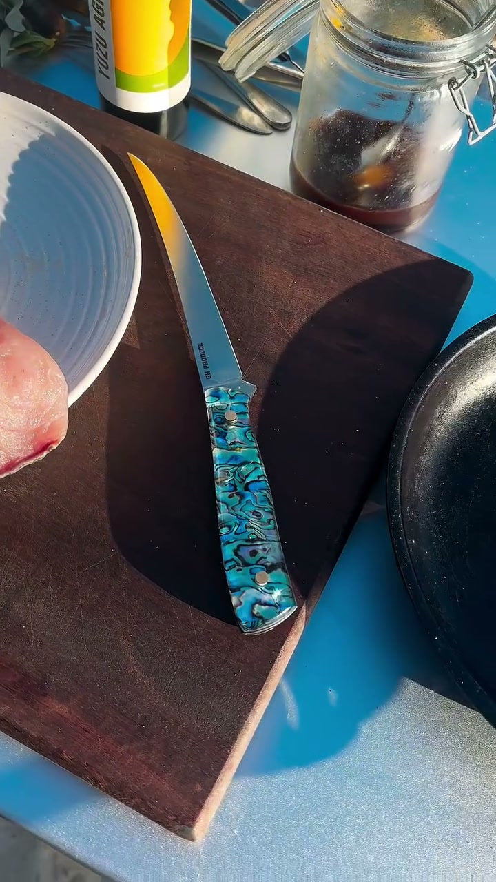 An Iron Gate knife on the board beside a Solidteknics pan
