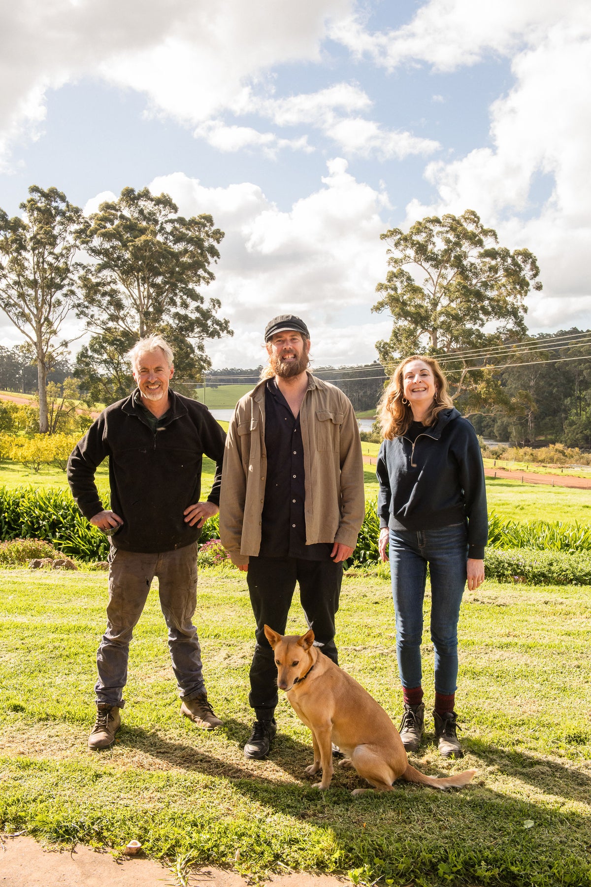 Chef Glen standing with the Lake Janis farmers and the farm dog