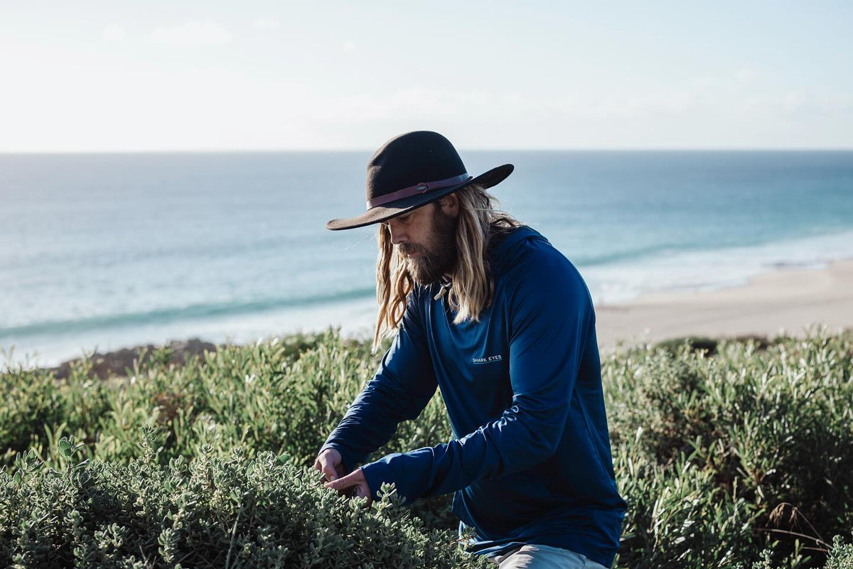 Chef Glen foraging on the coast in a Shark Eyes solar shirt