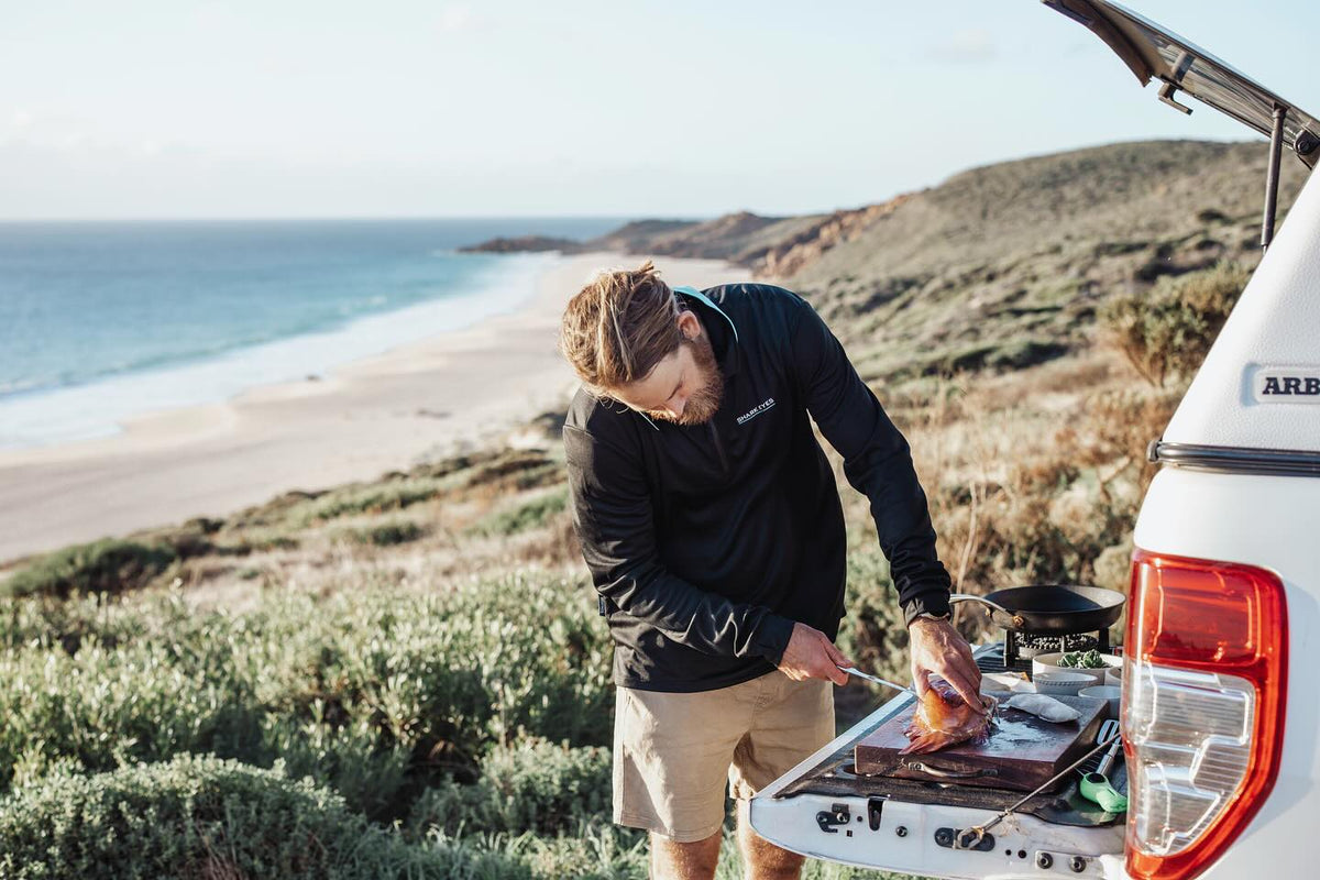 Chef Glen cooking his catch at the back of the car above the beach