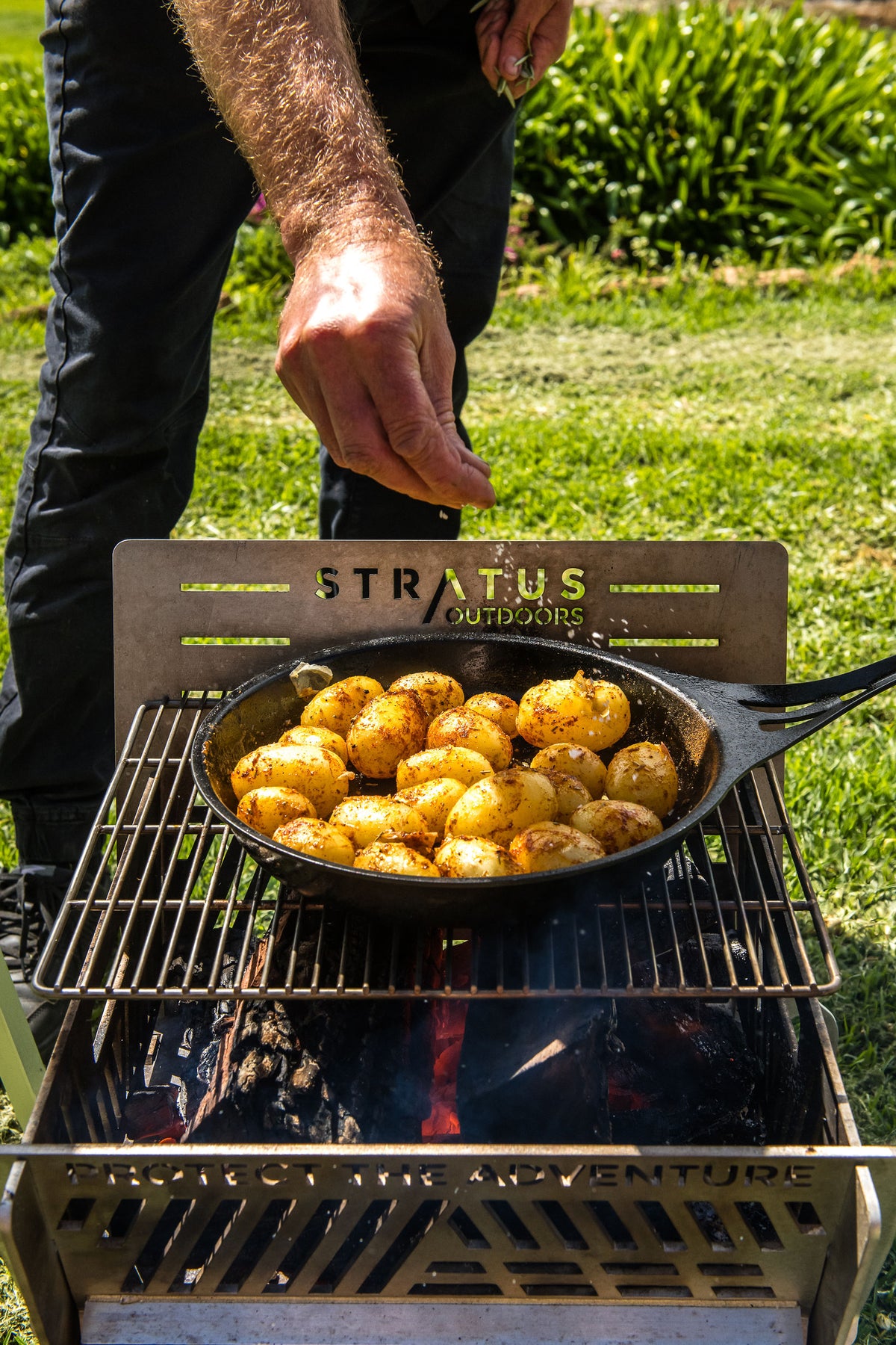 Chef Glen turning potatoes in a pan on the Stratus Outdoors grill