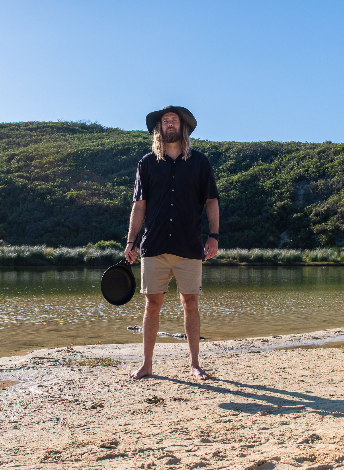 Chef Glen holding a Solidteknics pan on a riverbank